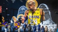 Fans gather at a mural of Kobe Bryant and his daughter Gianna