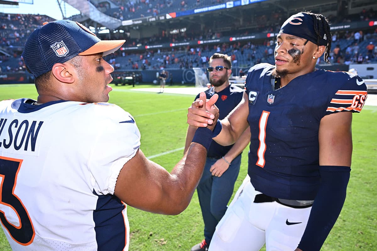 Chicago Bears quarterback Justin Fields (1), right, meets with Denver Broncos quarterback Russell Wilson (3) at midfield after their game at Soldier Field.