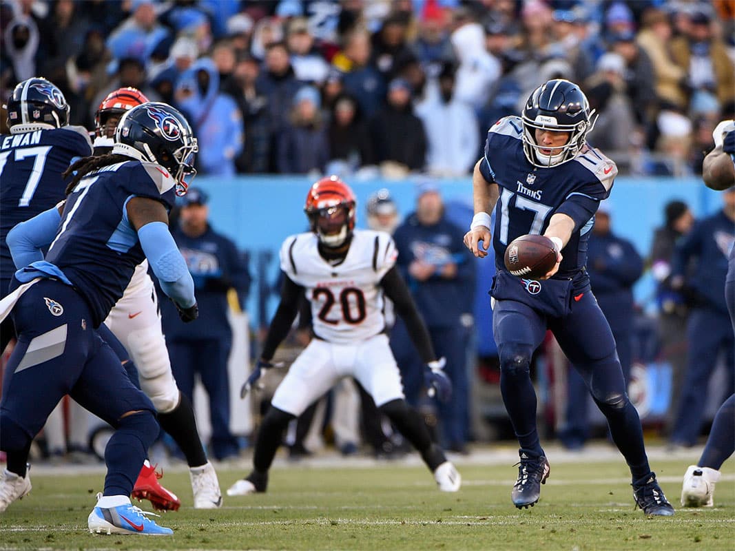 Tennessee Titans quarterback Ryan Tannehill (17) hands the ball to running back D'Onta Forman (7) against the Cincinnati Bengals during the first half during a AFC Divisional playoff football game at Nissan Stadium.