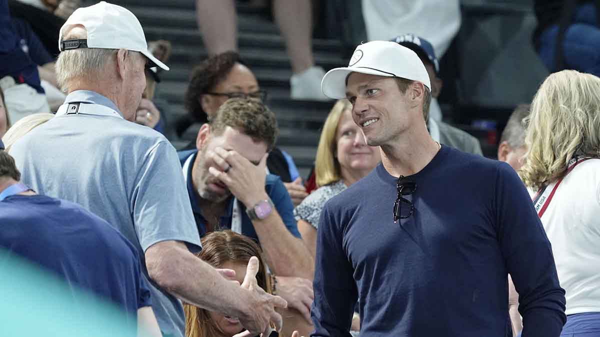 Stan Smith talks with Tom Brady on day three of the gymnastics event finals during the Paris 2024 Olympic Summer Games.