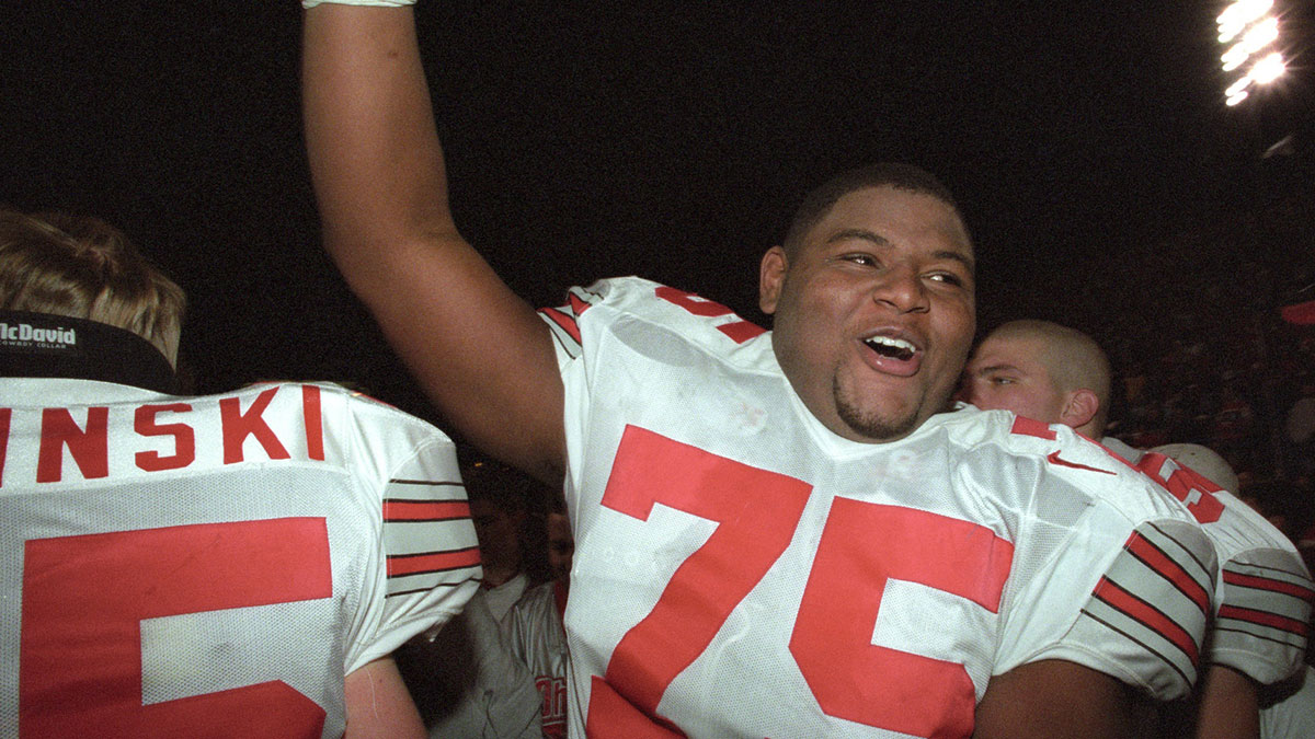 Ohio State Buckeyes tackle Orlando Pace (75) celebrates with fans after beating the Indiana Hoosiers 27-17 at Memorial Stadium. The victory sealed a Rose Bowl bid for the Buckeyes. 