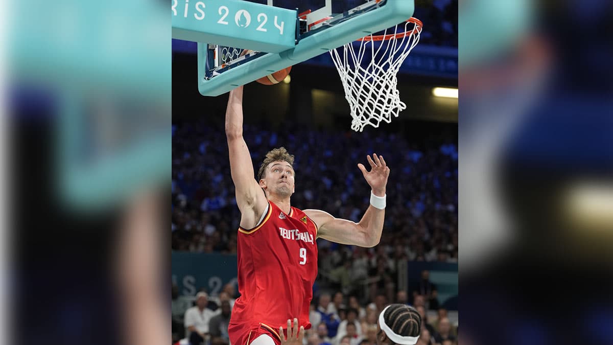 Germany guard Franz Wagner (9) shoots against France power forward Guerschon Yabusele (7) in the first half in a men’s group B basketball game during the Paris 2024 Olympic Summer Games at Stade Pierre-Mauroy. 