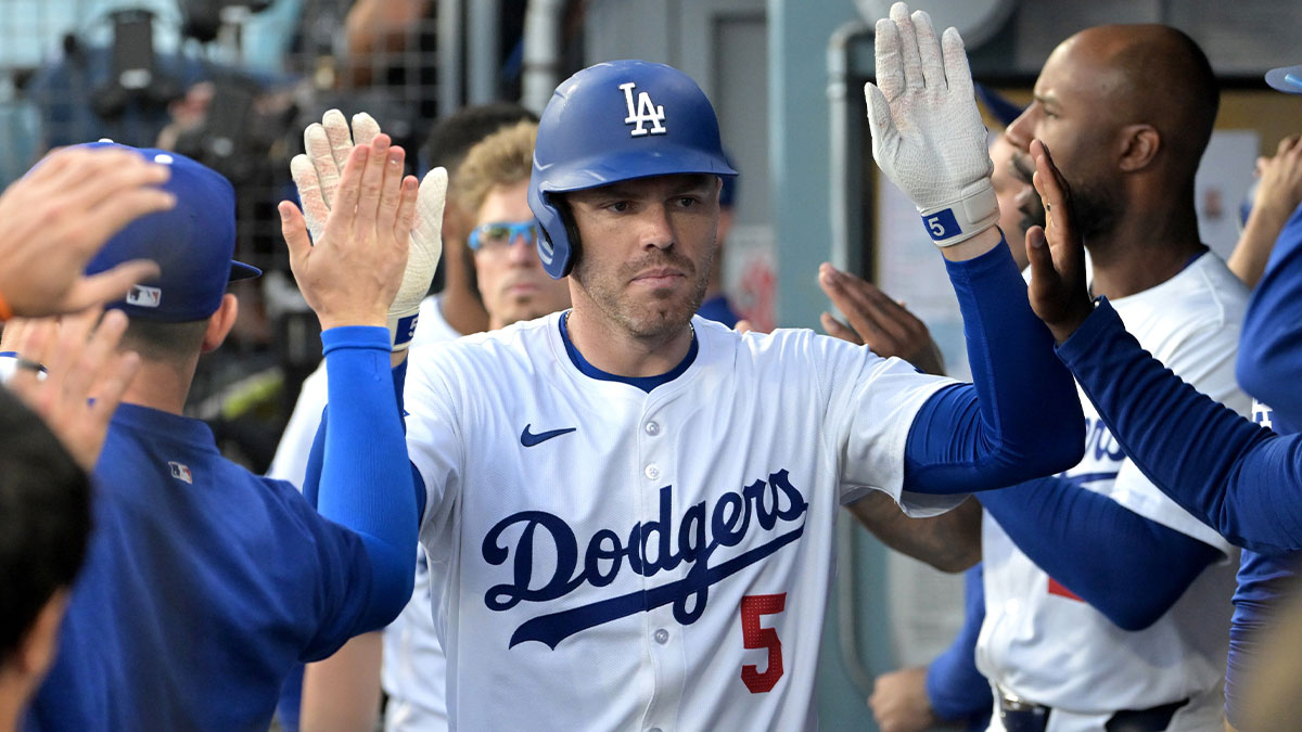 Los Angeles Dodgers first baseman Freddie Freeman (5) is congratulated in the dugout after a solo home run in the first inning against the Pittsburgh Pirates at Dodger Stadium.