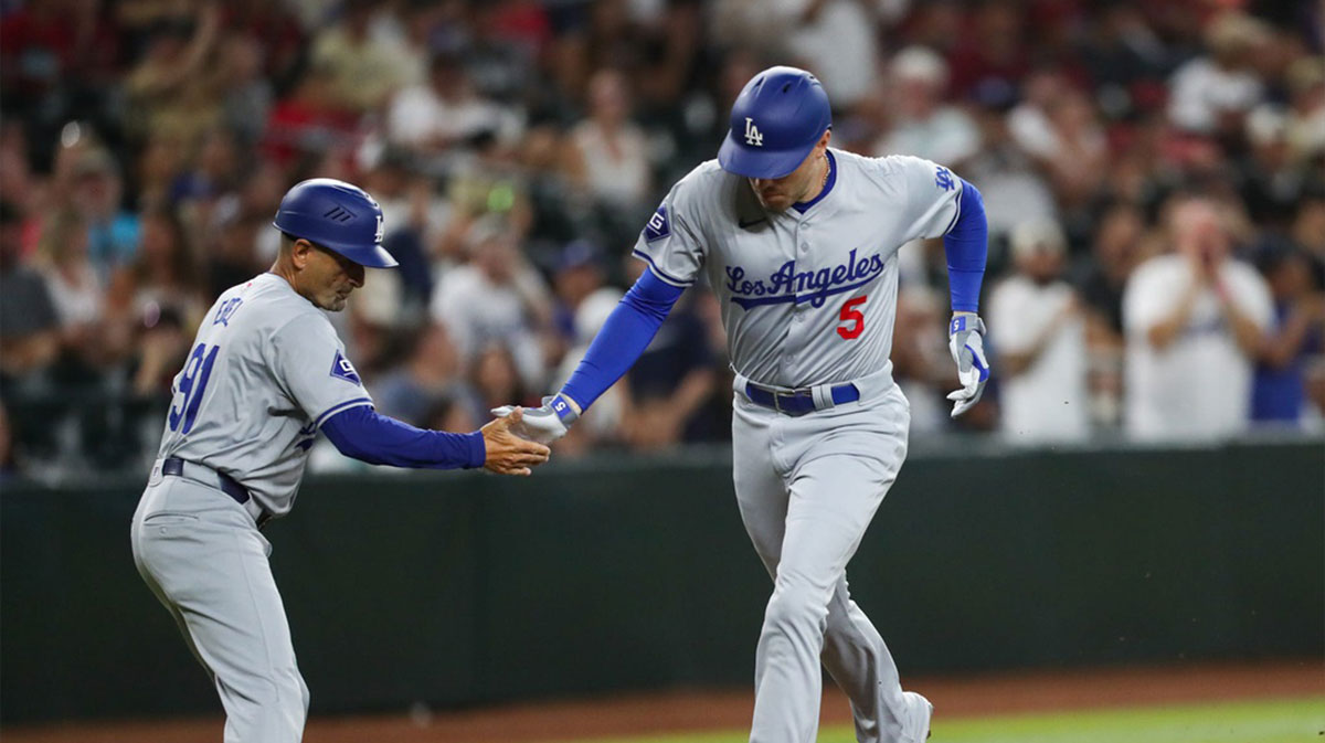 Los Angeles Dodgers first baseman Freddie freeman (5) high-fives third base coach Dino Abel after hitting a two-run home run on Aug. 30, 2024 at Chase Field in Phoenix.