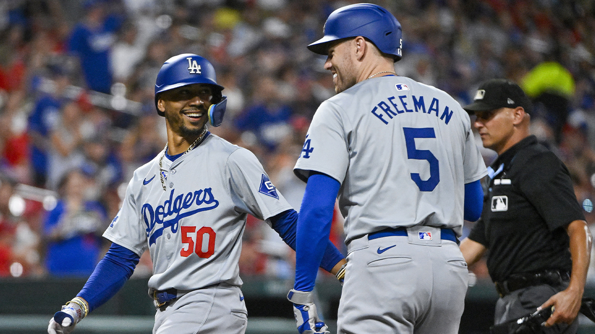 Los Angeles Dodgers right fielder Mookie Betts (50) celebrates with first baseman Freddie Freeman (5) after hitting a solo solo home run against the St. Louis Cardinals during the sixth inning at Busch Stadium.