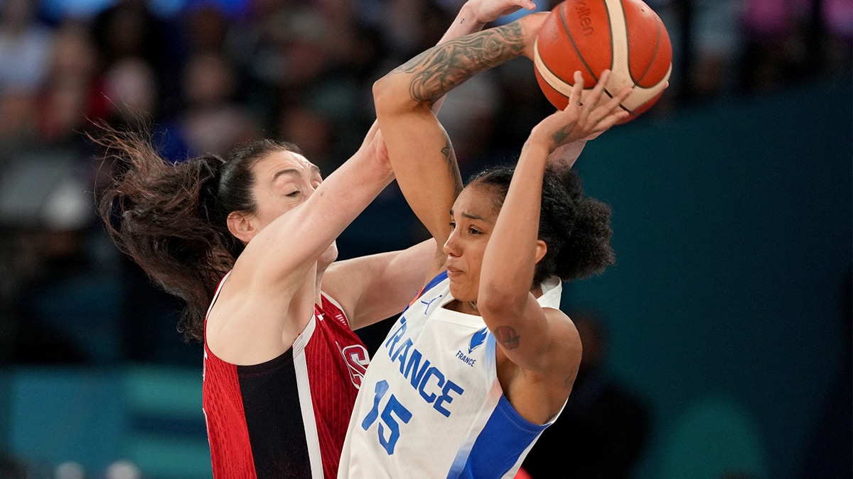  France forward Gabby Williams (15) passes against United States power forward Breanna Stewart (10) in the second half in the women's gold medal game during the Paris 2024 Olympic Summer Games.