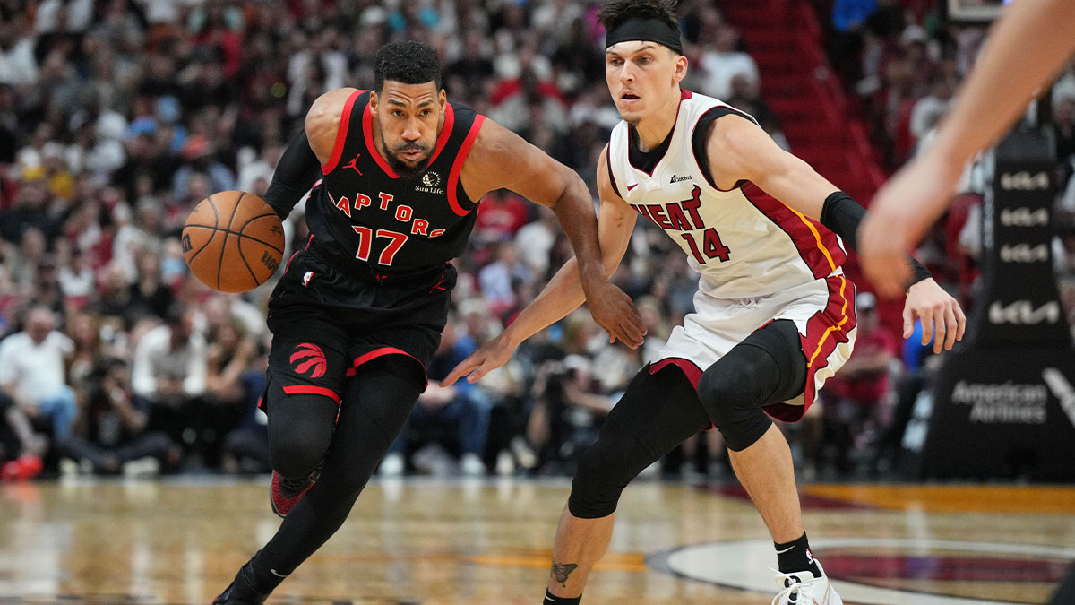 Toronto Raptors forward Garrett Temple (17) brings the ball up the court as Miami Heat guard Tyler Herro (14) follows the play during the second half at Kaseya Center.