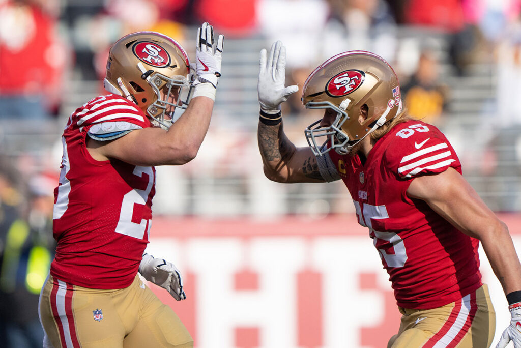 San Francisco 49ers running back Christian McCaffrey (23) and tight end George Kittle (85) celebrate during the second quarter against the Washington Commanders at Levi's Stadium.