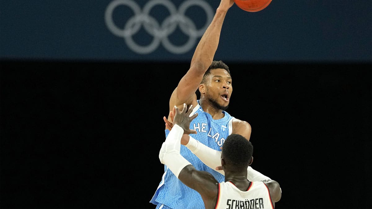 Greece small forward Giannis Antetokounmpo (34) passes the ball against Germany point guard Dennis Schroder (17) during a menís basketball quarterfinal game during the Paris 2024 Olympic Summer Games at Accor Arena. 