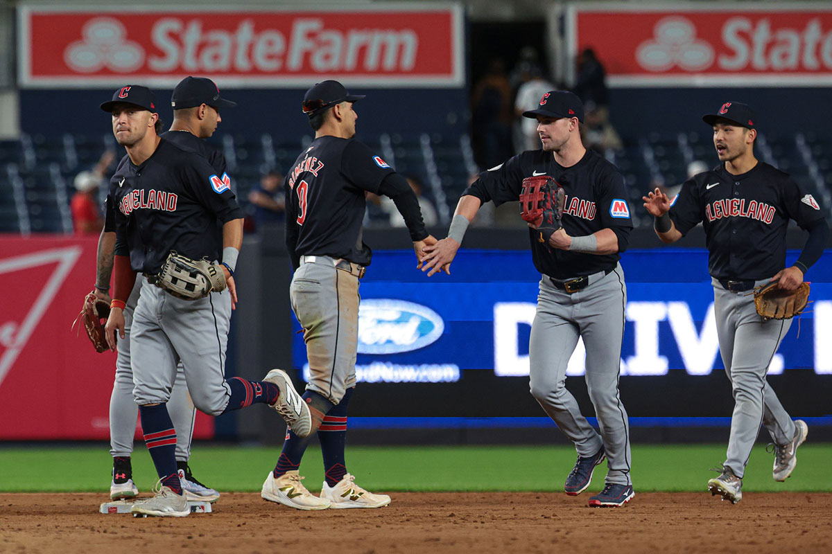 Cleveland Guardians second baseman Andres Gimenez (0) celebrates with teammates after defeating the New York Yankees in twelve innings at Yankee Stadium.