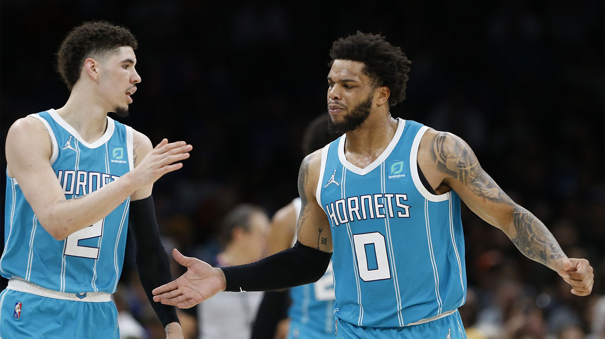 Hornets guard LaMelo Ball (2) and forward Miles Bridges (0) celebrate between plays against the Oklahoma City Thunder during the second half at Paycom Center. Charlotte won 134-116. 