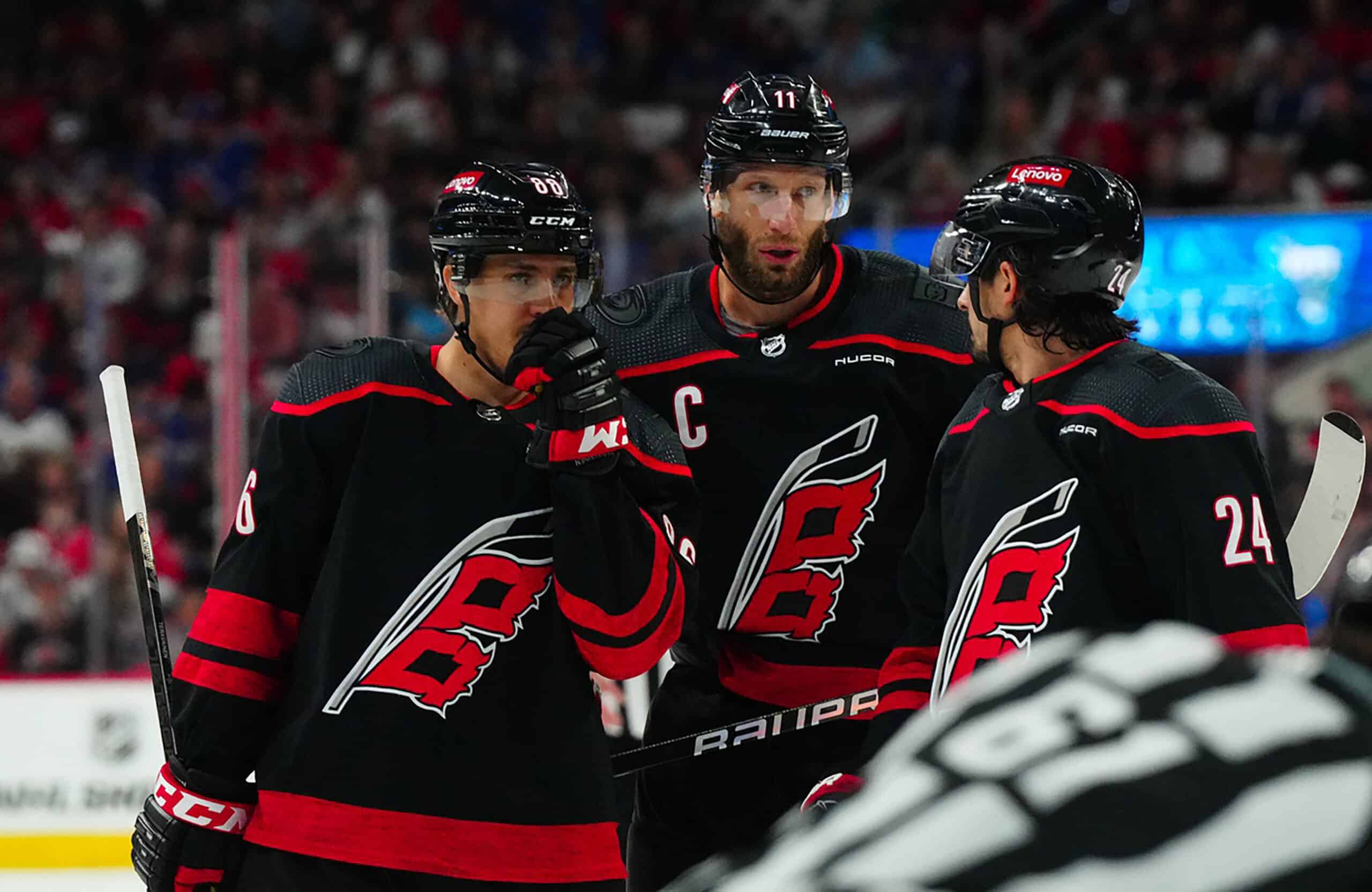 Carolina Hurricanes left wing Teuvo Teravainen (86) center Jordan Staal (11) and center Seth Jarvis (24) talk against the New York Rangers during the first period in game three of the second round of the 2024 Stanley Cup Playoffs at PNC Arena.