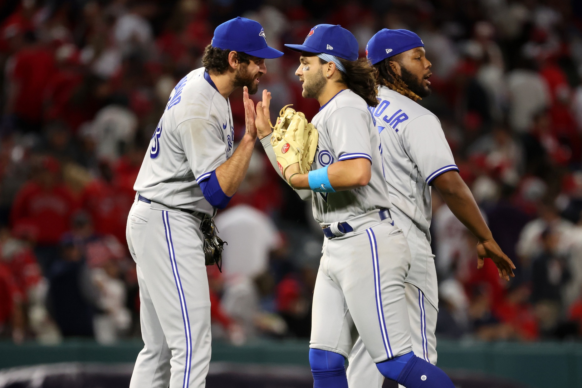 Toronto Blue Jays relief pitcher Jordan Romano (68) and shortstop Bo Bichette (11) celebrate a victory after defeating the Los Angeles Angels 4-3 at Angel Stadium.