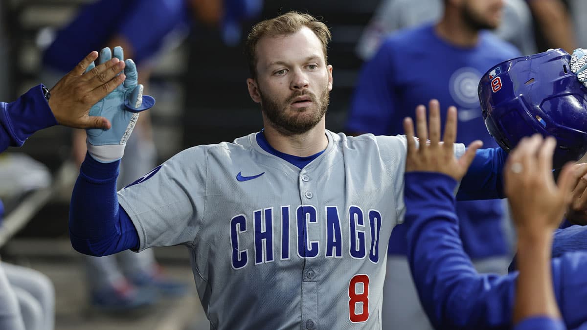 Chicago Cubs outfielder Ian Happ (8) celebrates with teammates in the dugout after hitting a solo home run against the Chicago White Sox during the first inning at Guaranteed Rate Field.