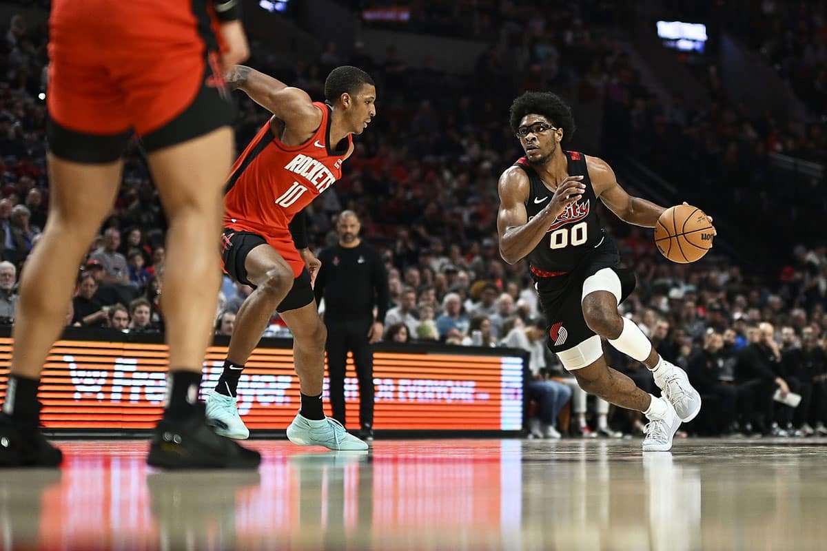 Portland Trail Blazers guard Scoot Henderson (00) drives to the basket during the second half against Houston Rockets forward Jabari Smith Jr. (10) at Moda Center