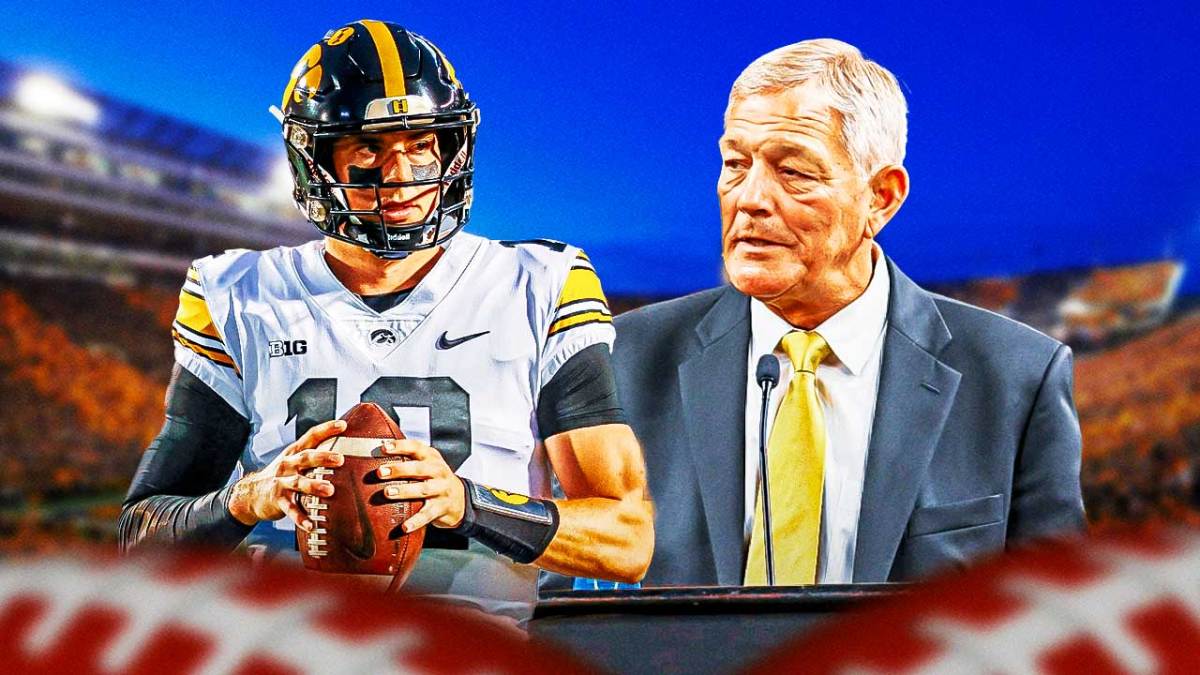 Cade McNamara smiles next to Kirk Ferentz in Iowa gear