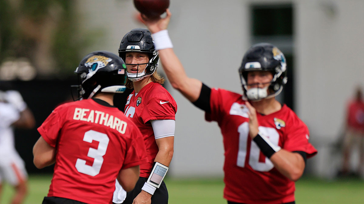 Jacksonville Jaguars quarterback Trevor Lawrence (16) looks on as quarterback Mac Jones (10) passes next to quarterback C.J. Beathard (3) during a combined NFL football training camp session between the Tampa Bay Buccaneers and Jacksonville Jaguars Thursday, Aug. 15, 2024 at EverBank Stadium’s Miller Electric Center in Jacksonville, Fla. [Corey Perrine/Florida Times-Union]