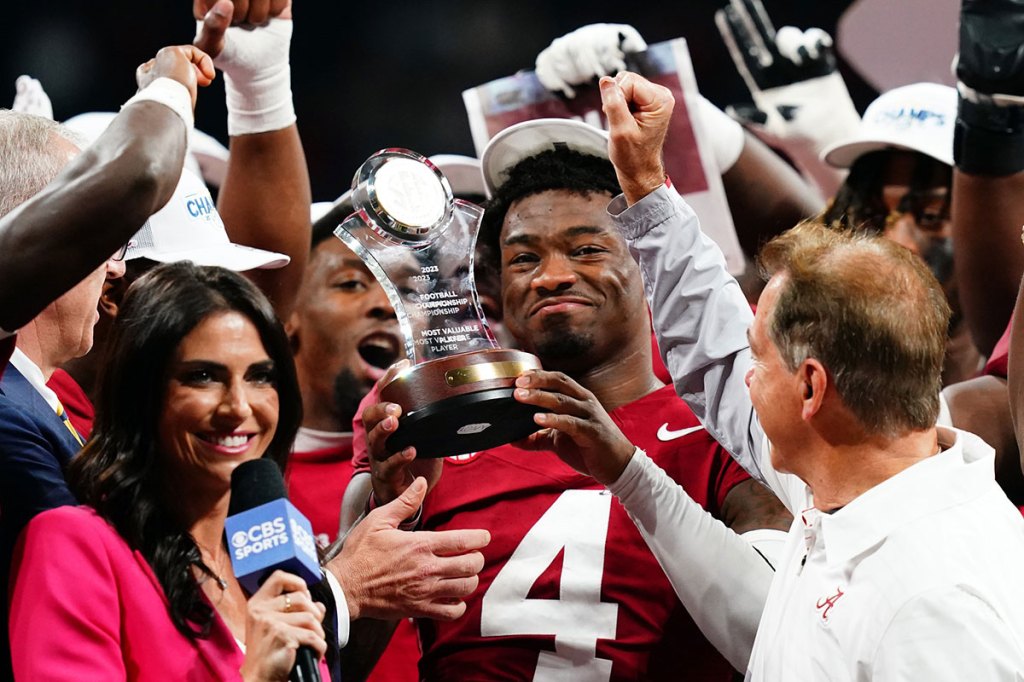 Alabama Crimson Tide quarterback Jalen Milroe (4) celebrates with the most valuable player trophy after the Alabama Crimson Tide defeated the Georgia Bulldogs in the SEC Championship at Mercedes-Benz Stadium.