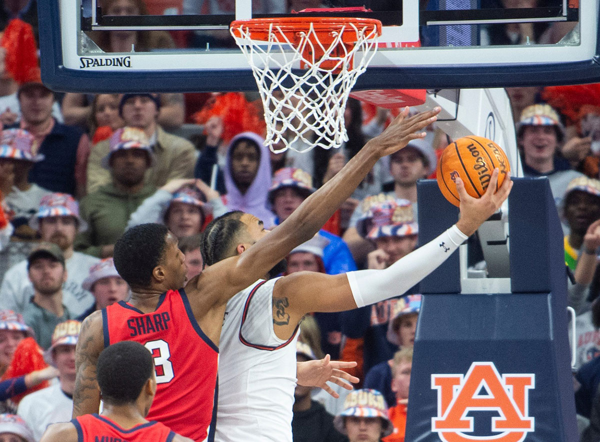 Ole Miss Rebels forward Jamarion Sharp (3) blocks Auburn Tigers forward Johni Broome (4) as Auburn Tigers takes on Ole Miss Rebels at Neville Arena in Auburn, Ala., on Saturday, Jan. 20, 2024. Auburn Tigers lead Ole Miss Rebels 46-27 at halftime.