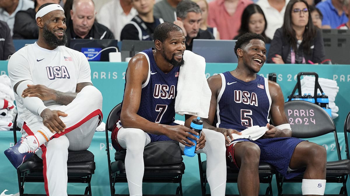  United States guard LeBron James (6), guard Kevin Durant (7) and guard Anthony Edwards (5) on the bench in the fourth quarter against Puerto Rico during the Paris 2024 Olympic Summer Games at Stade Pierre-Mauroy.