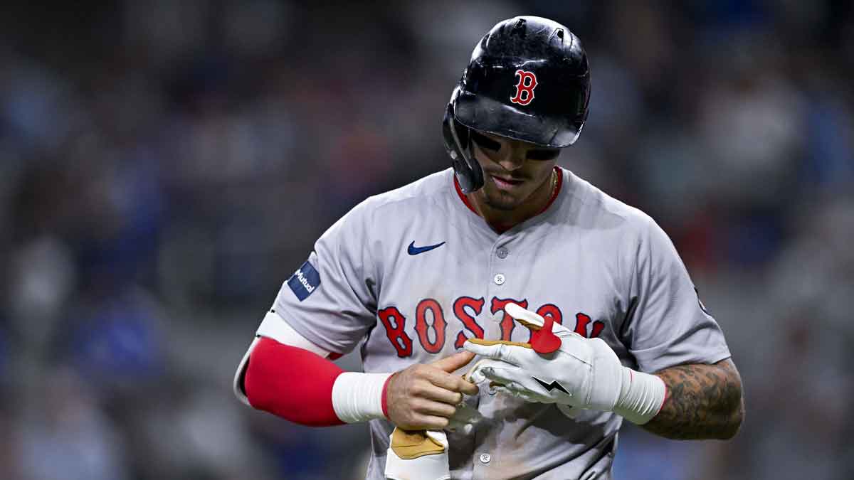 Aug 3, 2024; Arlington, Texas, USA; Boston Red Sox left fielder Jarren Duran (16) removes his batting gloves after he strikes out to end the inning against the Texas Rangers during the eighth inning at Globe Life Field. 