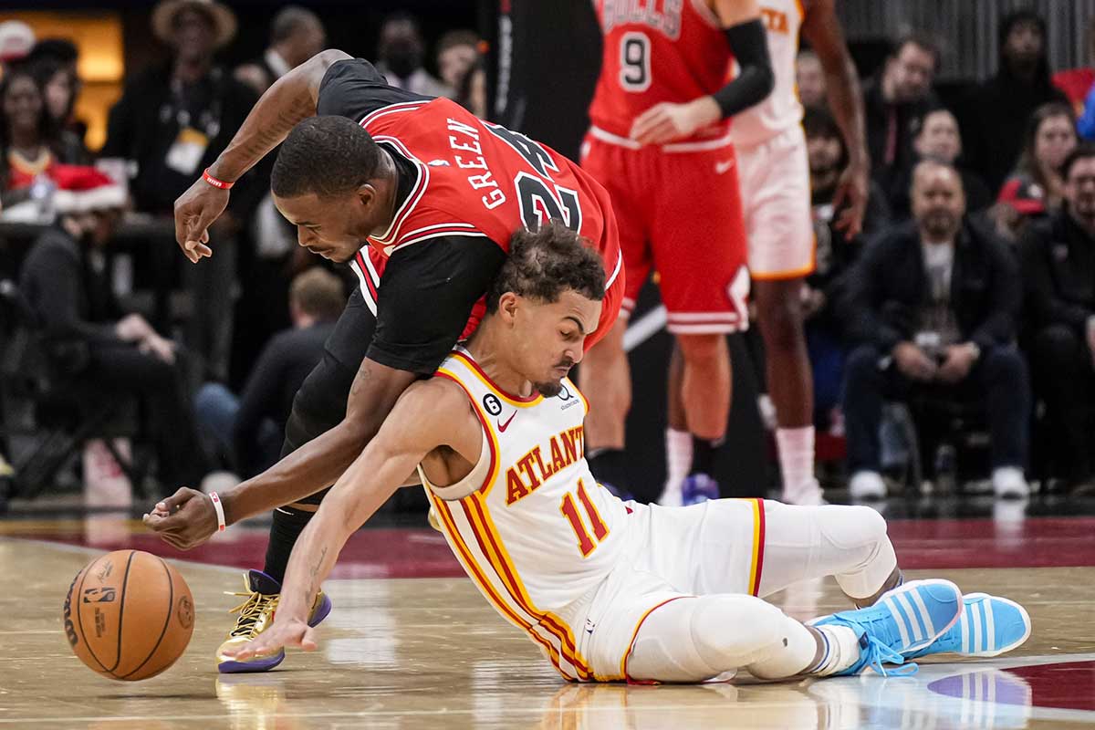 Chicago Bulls forward Javonte Green (24) and Atlanta Hawks guard Trae Young (11) fight for the ball on the floor during the second half at State Farm Arena.
