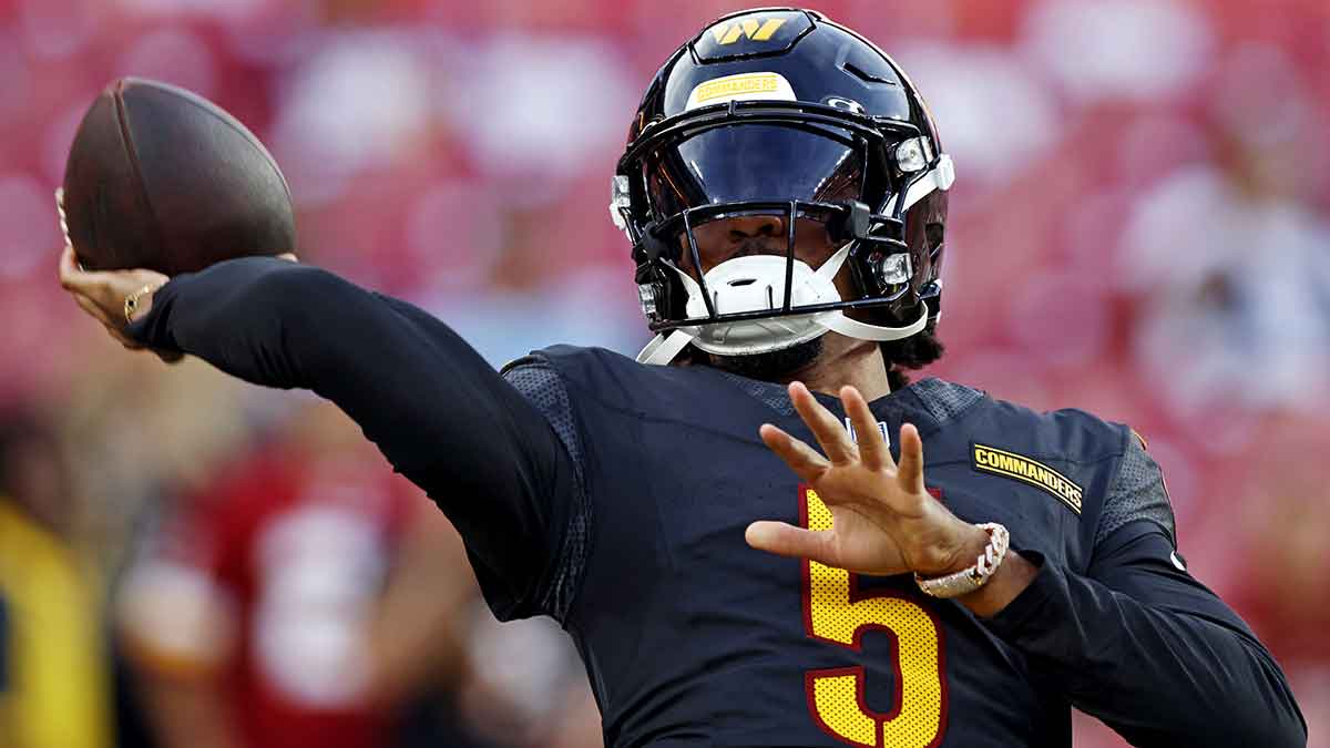 Washington Commanders quarterback Jayden Daniels (5) warms up before playing a preseason game against the New England Patriots at Commanders Field.