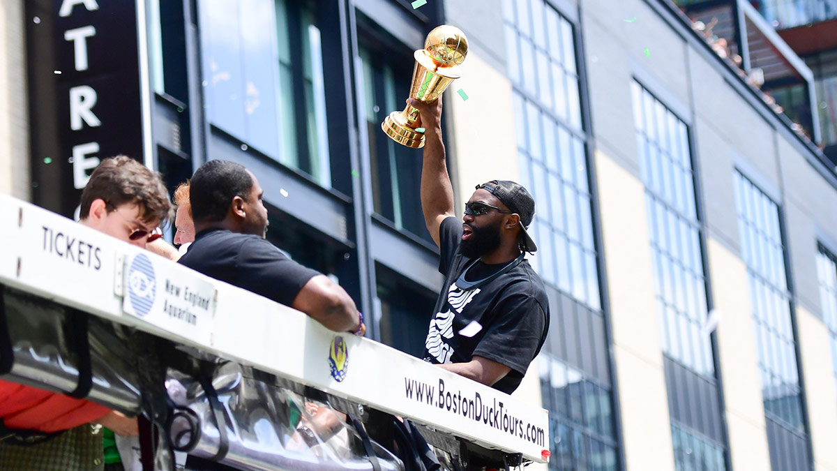 Boston Celtics player Jaylen Brown holds the MVP trophy during the Boston Celtics Championship parade.