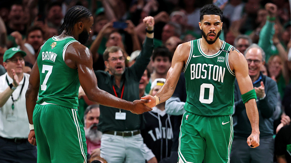 Boston Celtics forward Jayson Tatum (0) celebrates with guard Jaylen Brown (7) after a play against the Dallas Mavericks in game five of the 2024 NBA Finals at TD Garden. 