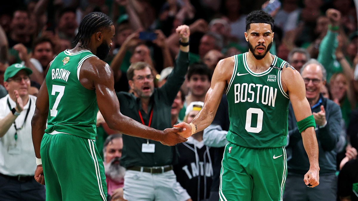 Boston Celtics forward Jayson Tatum (0) celebrates with guard Jaylen Brown (7) after a play against the Dallas Mavericks in game five of the 2024 NBA Finals at TD Garden.