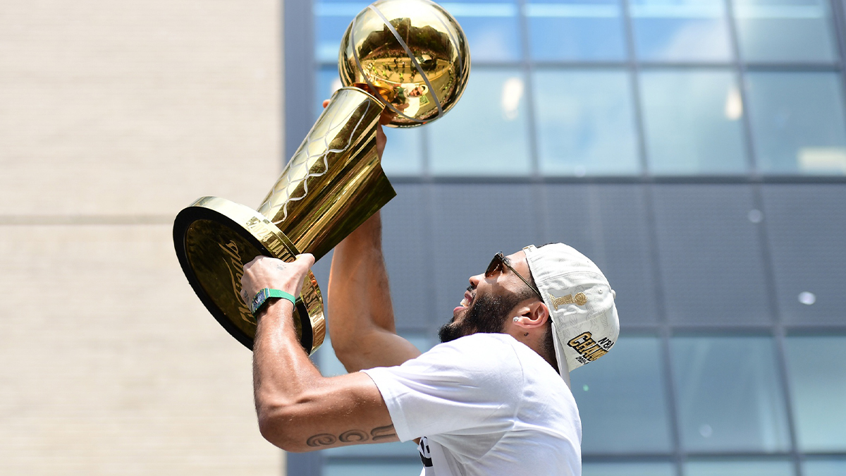Jayson Tatum holds the Larry OíBrien trophy