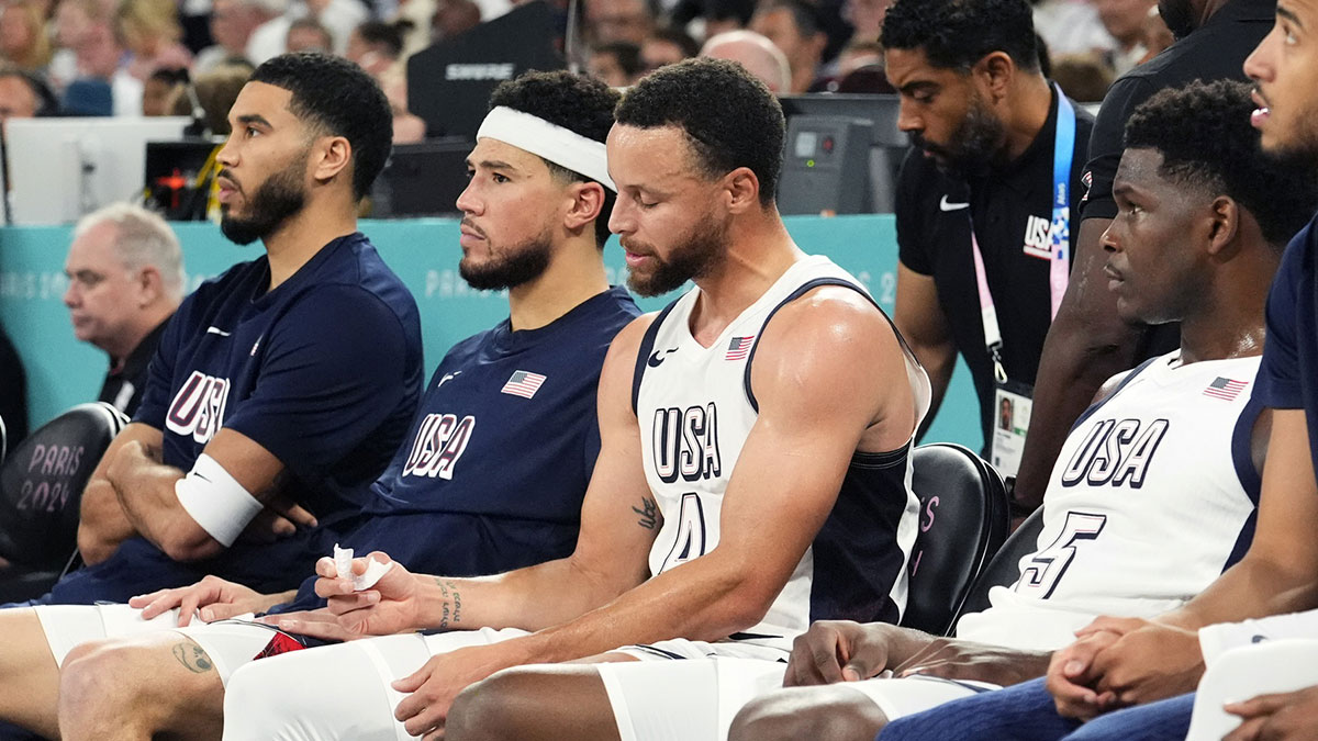 nited States small forward Jayson Tatum (10), guard Devin Booker (15), shooting guard Stephen Curry (4) and guard Anthony Edwards (5) look on from the bench during the first half against Serbia in a men's basketball semifinal game during the Paris 2024 Olympic Summer Games at Accor Arena.