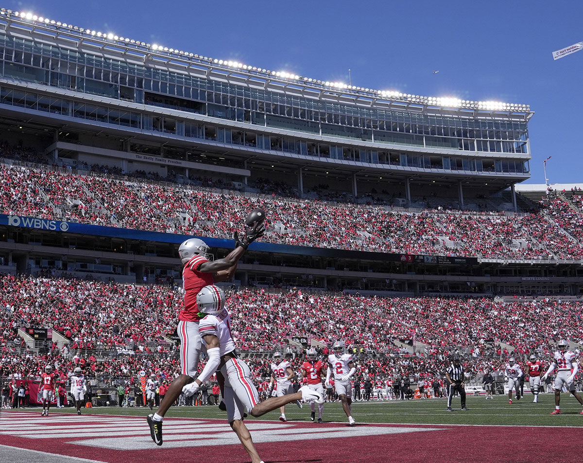 Ohio State Buckeyes wide receiver Jeremiah Smith (4) playing for the scarlet team can't reel in a pass while defended by cornerback Davison Igbinosun (1) of the gray team of the during the first half of the LifeSports Spring Game at Ohio Stadium on Saturday.