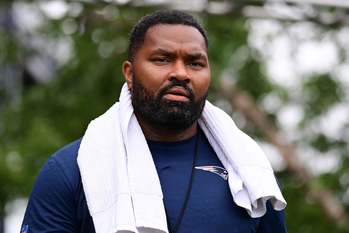 New England Patriots head coach Jerod Mayo walks to the podium for a press conference before training camp at Gillette Stadium.