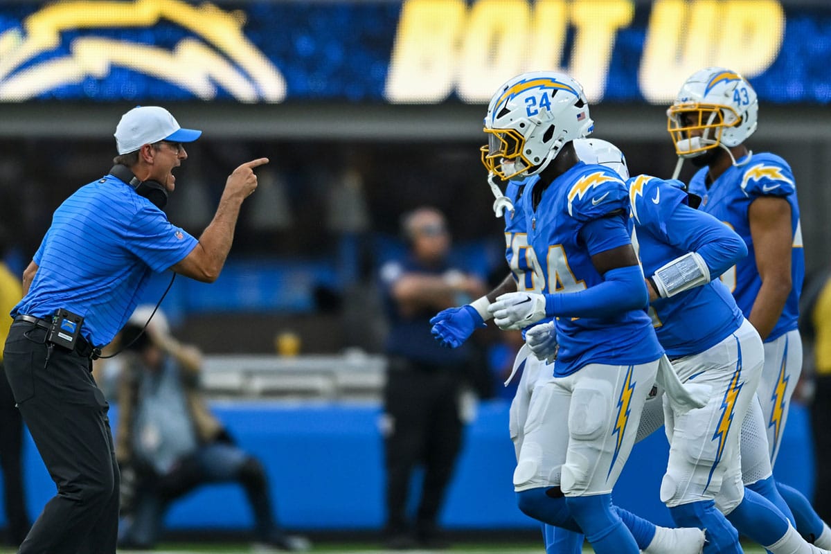 Los Angeles Chargers head coach Jim Harbaugh reacts with the team after scoring a touchdown against the Seattle Seahawks during the third quarter at SoFi Stadium.