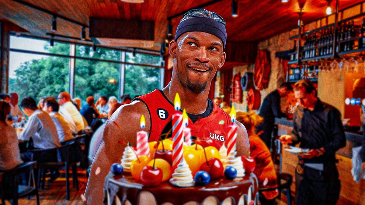 Miami Heat star Jimmy Butler delivering a birthday cake in a busy restaurant in Miami