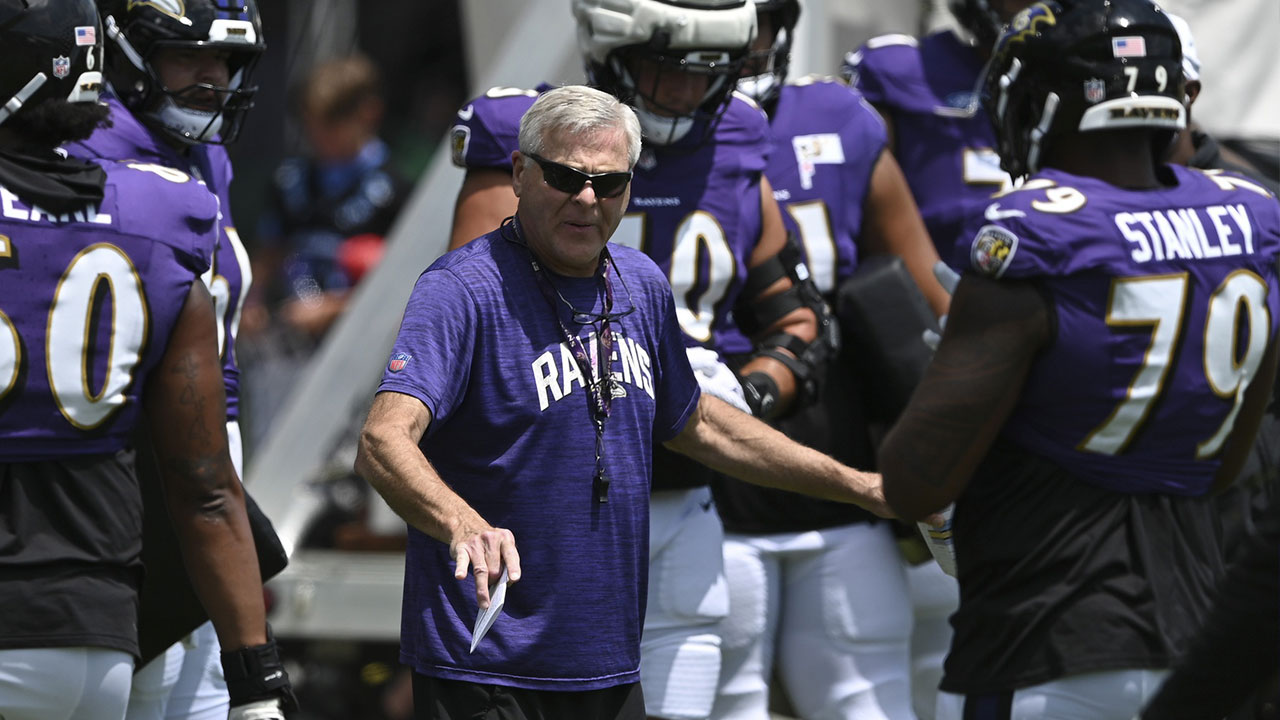 Baltimore Ravens offensive line coach Joe D'Alessandris speaks with lineman during the afternoon session of training camp at the Under Armour Performance Center.