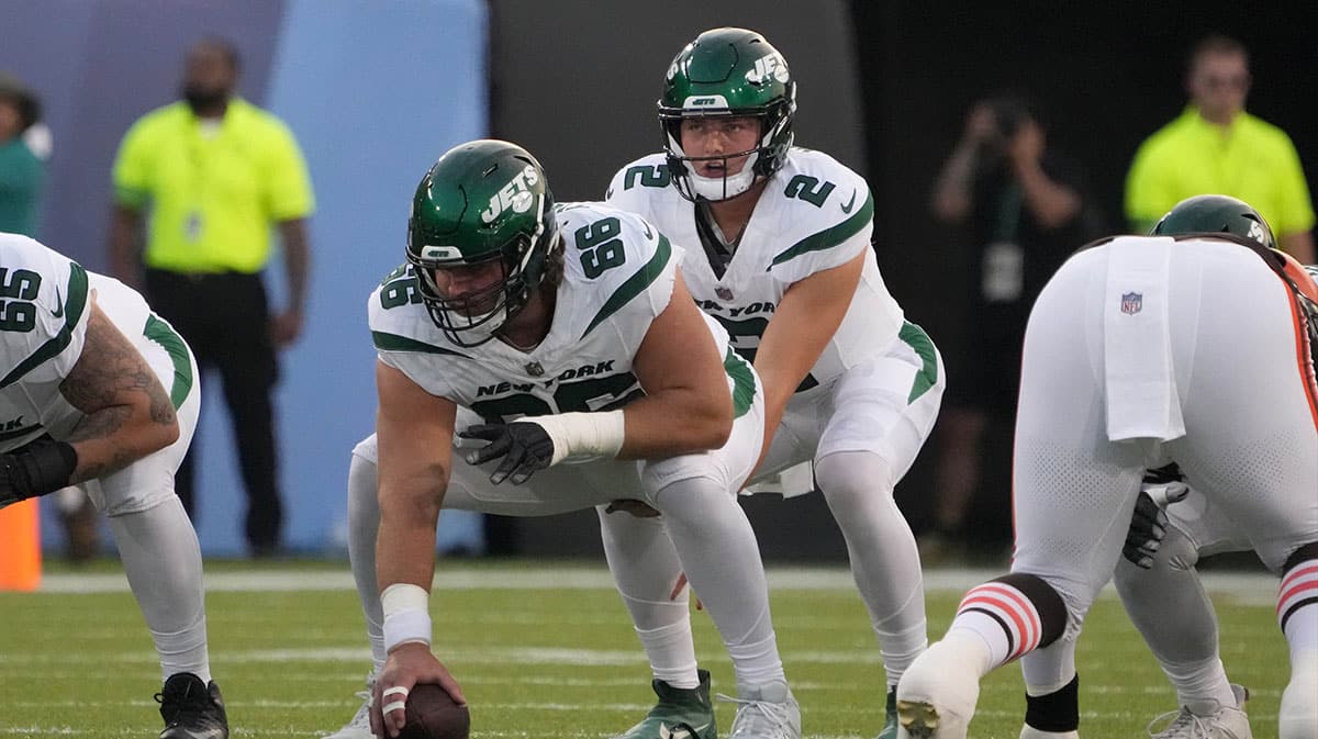 New York Jets quarterback Zach Wilson (2) takes the snap from center Joe Tippmann (66) against the Cleveland Browns during the first half at Tom Benson Hall of Fame Stadium.