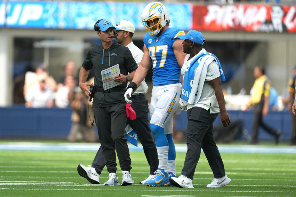 Los Angeles Chargers linebacker Joey Bosa (97) walks off the field with Brandon Staley after suffering an injury against the Jacksonville Jaguars in the first half at SoFi Stadium. 
