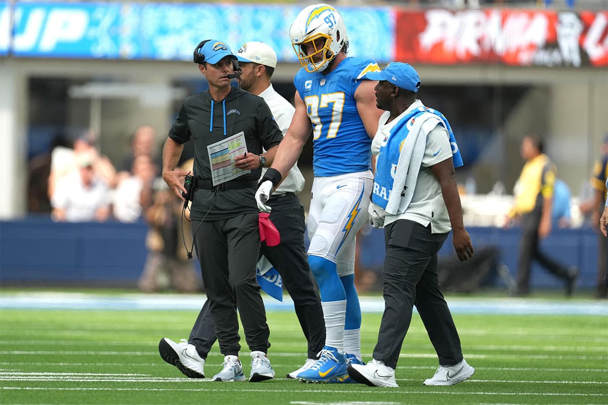 Los Angeles Chargers linebacker Joey Bosa (97) walks off the field with Brandon Staley after suffering an injury against the Jacksonville Jaguars in the first half at SoFi Stadium.
