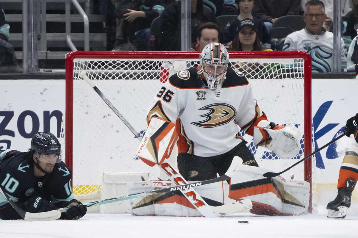 The puck sits in front of Anaheim Ducksgoalie John Gibson (36) and. Seattle Kraken forward Matty Beniers (10) during the first period at Climate Pledge Arena.