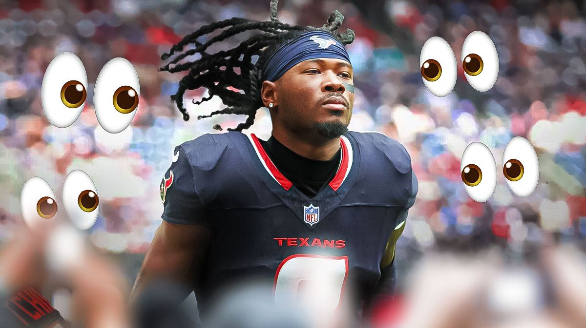 Photo: John Metchie III in Texans jersey in action with peeping eyes around him