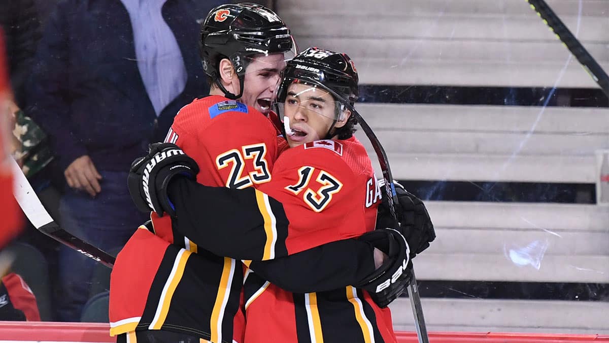 Calgary Flames left wing Johnny Gaudreau (13) celebrates with center Sean Monahan (23) after scoring a goal in the first period against the Buffalo Sabres at Scotiabank Saddledome.