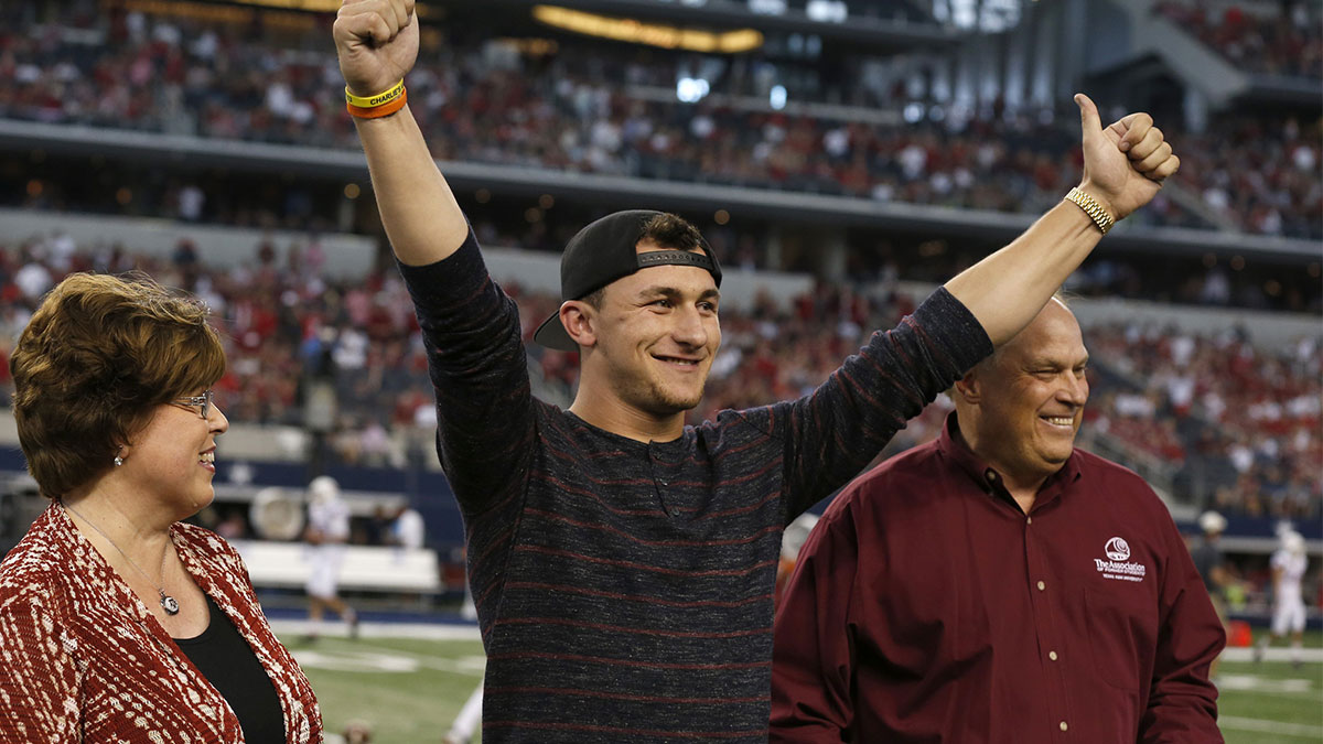 Texas A&M Aggies former quarterback Johnny Manziel is presented his Aggie ring during a ceremony at halftime against the Arkansas Razorbacks at AT&T Stadium.
