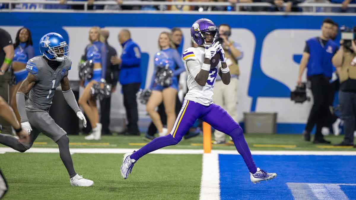 Minnesota Vikings wide receiver Jordan Addison (3) catches a pass for a touchdown in front of Detroit Lions cornerback Cameron Sutton (1) during second half at Ford Field.