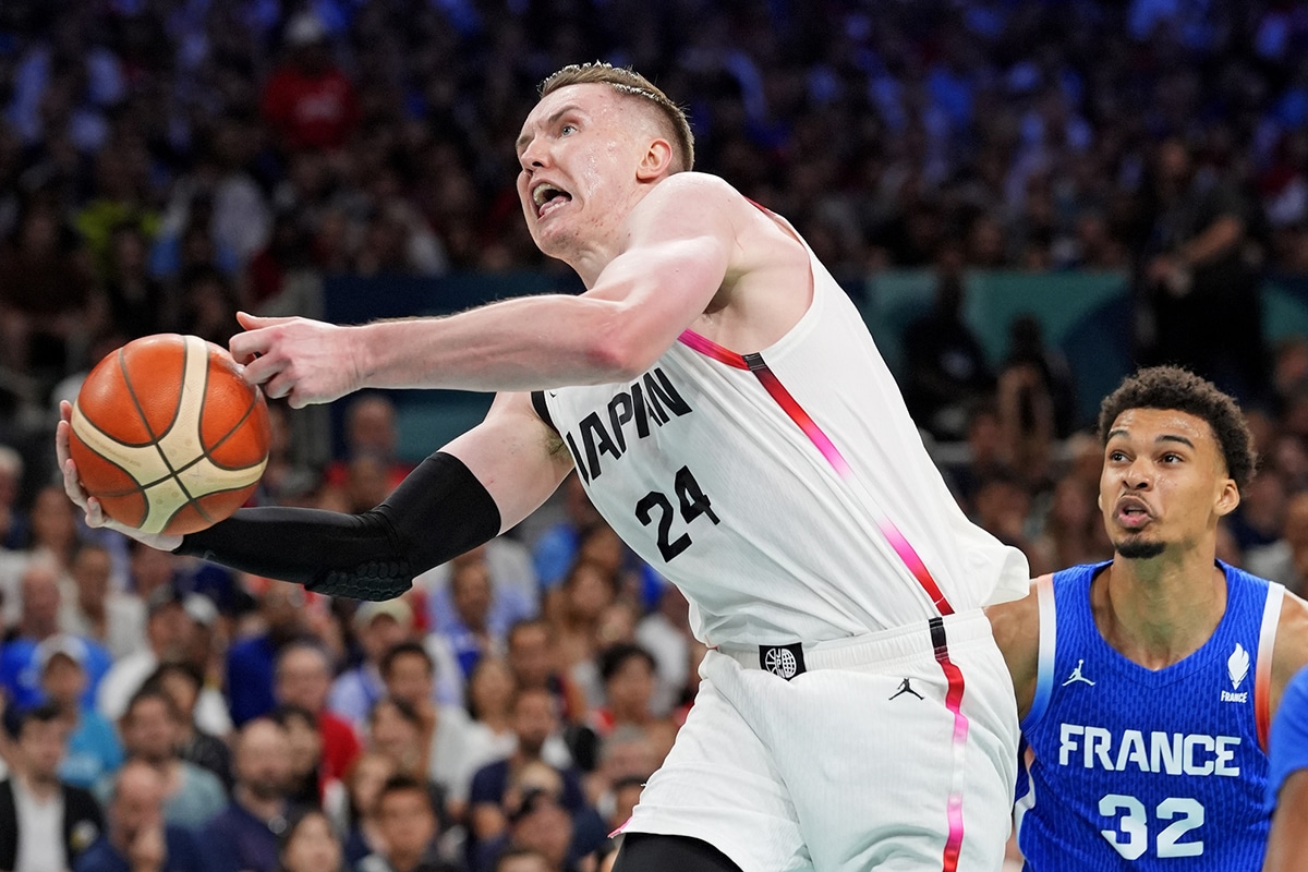 Japan centre Josh Hawkinson (24) grabs a rebound against France power forward Victor Wembanyama (32) in men’s basketball group B play during the Paris 2024 Olympic Summer Games at Stade Pierre-Mauroy.