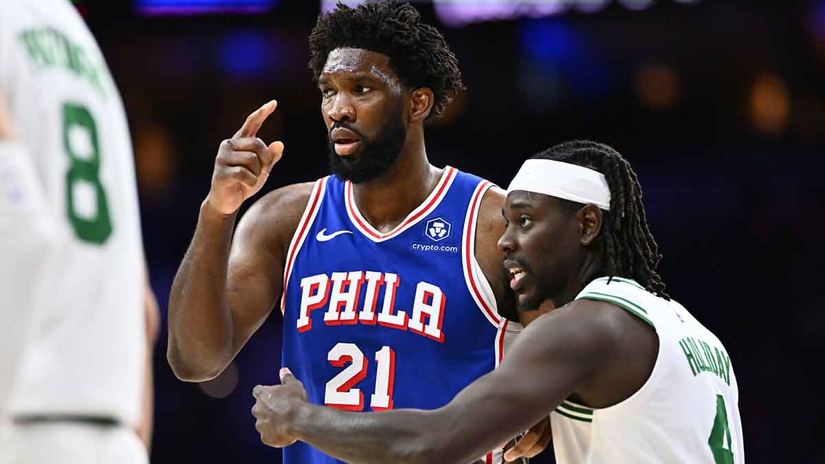 Boston Celtics guard Jrue Holiday (4) defends Philadelphia 76ers center Joel Embiid (21) in the third quarter at Wells Fargo Center.