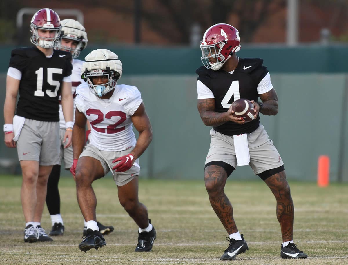 Tuscaloosa, Alabama, USA; Jalen Milroe turns to hand the ball off to Justice Haynes during practice for the Alabama Crimson Tide football team Wednesday.