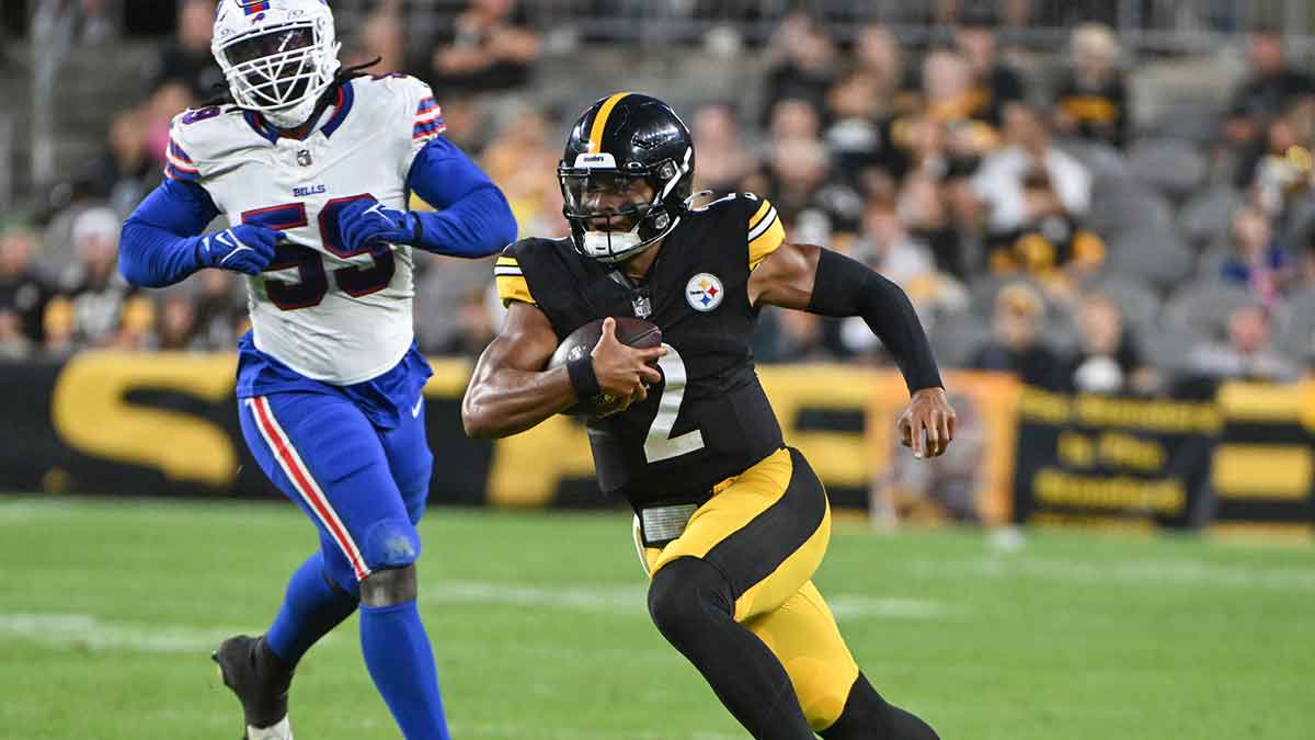 Pittsburgh Steelers quarterback Justin Fields (2) runs away from Buffalo Bills defensive end Kingsley Jonathan (59) during the second quarter at Acrisure Stadium.