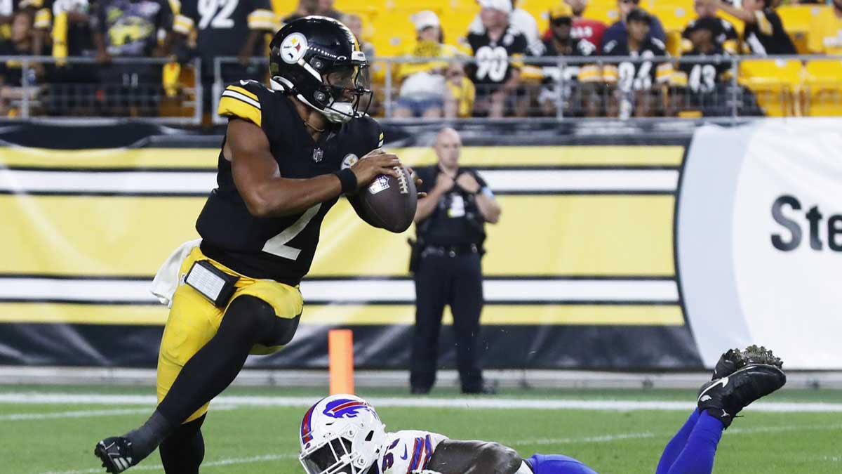 Pittsburgh Steelers quarterback Justin Fields (2) steps out of a tackle attempt of Buffalo Bills defensive tackle DeShawn Williams (93) during the fourth quarter at Acrisure Stadium.Buffalo won 9-3.